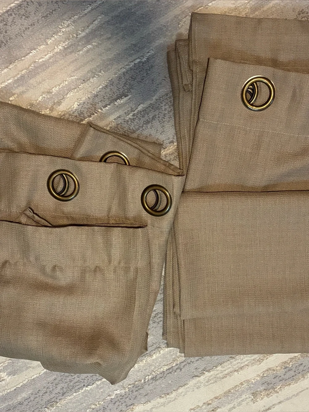 Tan grommet-top curtain panel measures approximately 90 in length 50 width. EUC